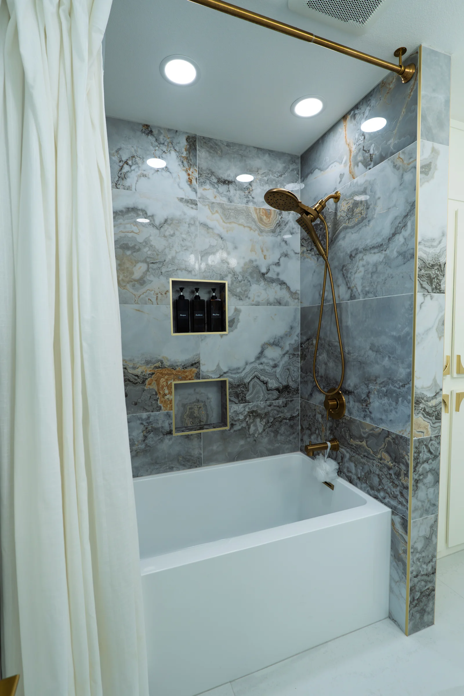 Blue marble walk-in shower with glass enclosure and brass fixtures, Portland OR bathroom remodel